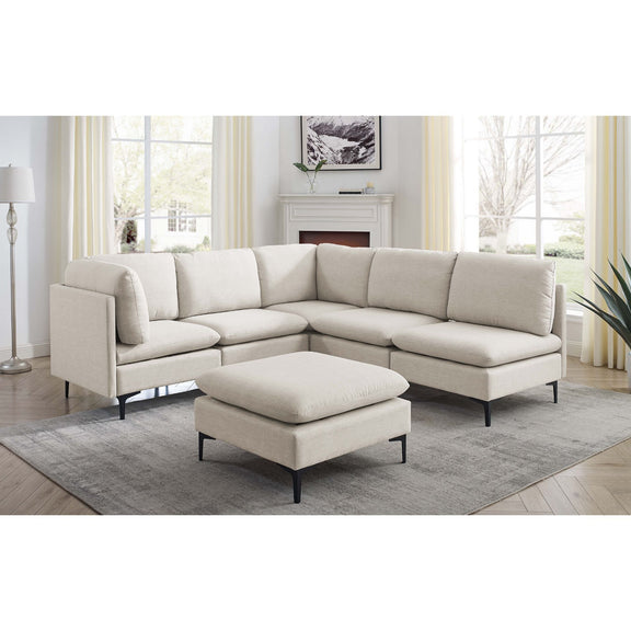 Beige L-shaped sectional with ottoman and tall black legs, rounded arms
