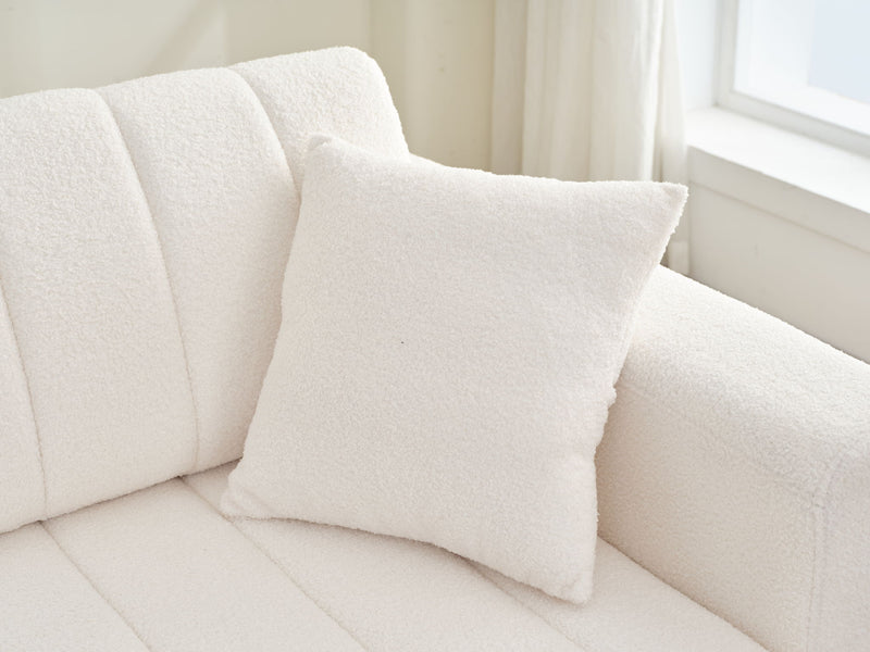 Beige lamb wool sofa back and seat cushions with square throw pillow