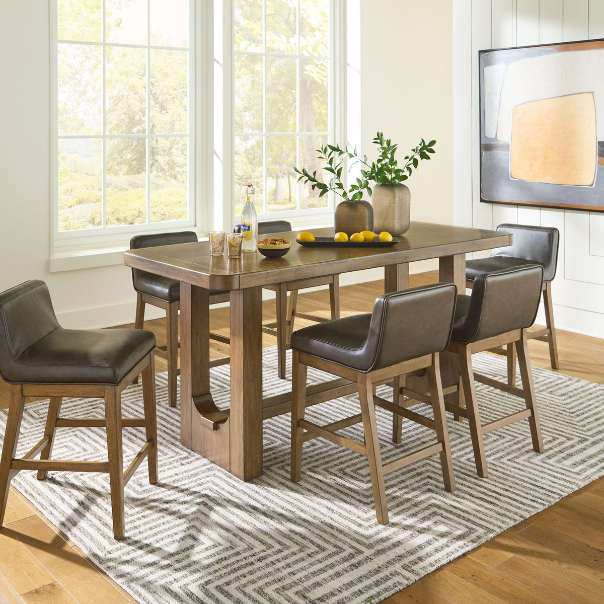 Rectangular dining counter table set, light brown wood with four dark gray chairs.