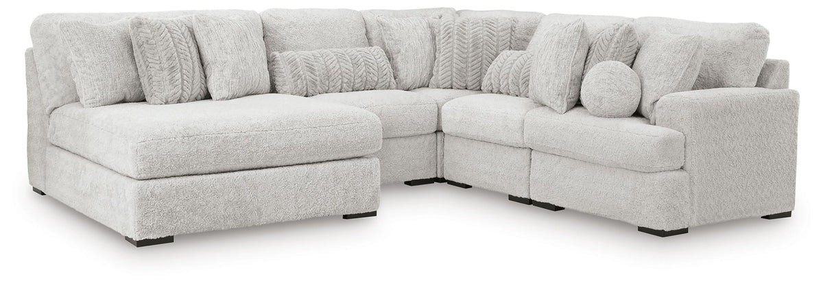 White sectional sofa with chaise-style corner and padded, rounded seat arms