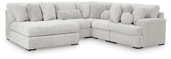 White sectional sofa with chaise-style corner and padded, rounded seat arms