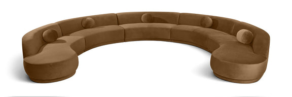 Camel brown velvet sectional sofa with rounded, button-tufted seat cushions.