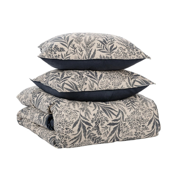 Denim blue leaf-pattern duvet set, stacked with pillow shams and duvet