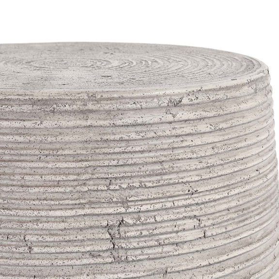 Gray outdoor table top edge close-up with concentric grooves and speckled finish