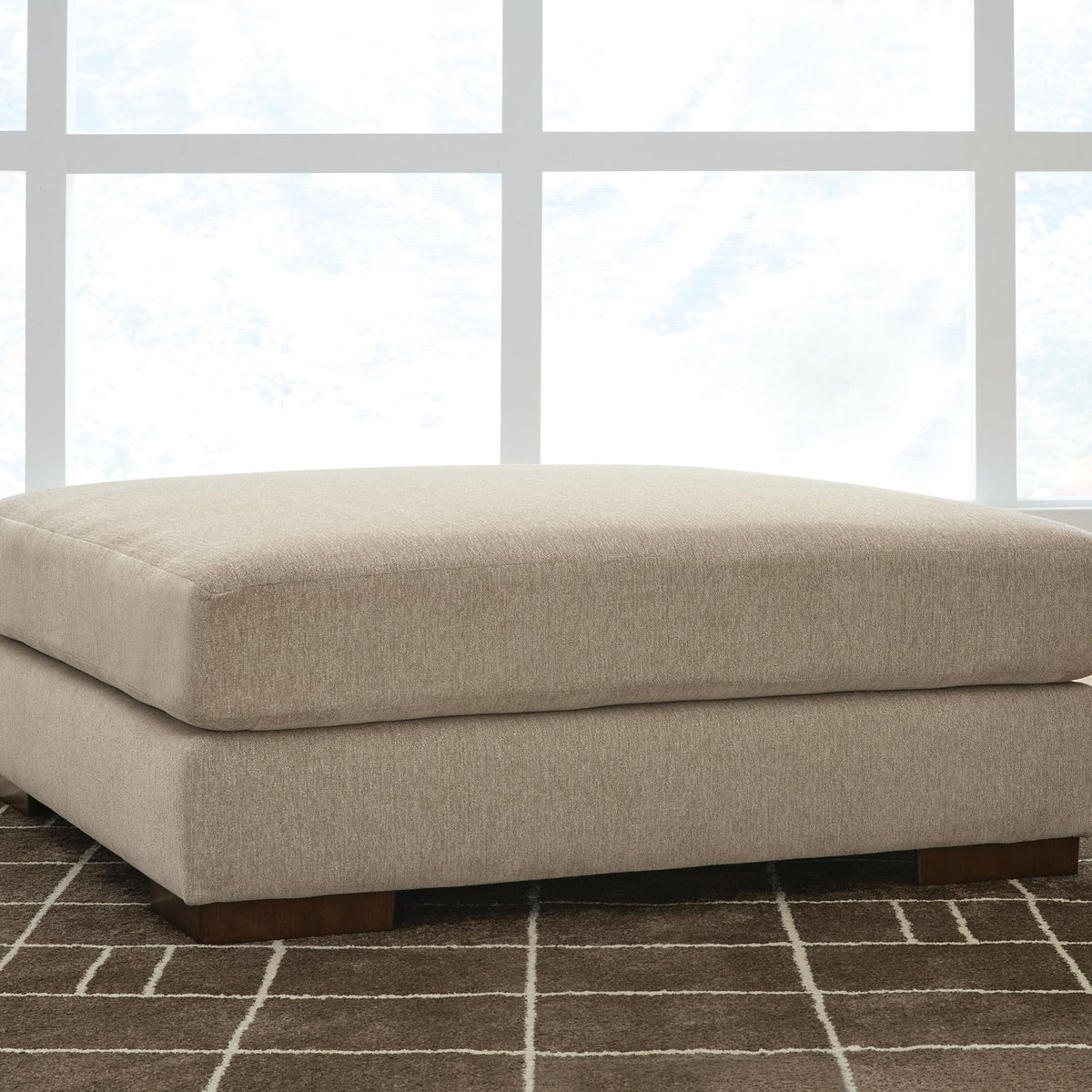 Linenhause oversized ottoman with soft dune beige fabric top and dark wooden legs