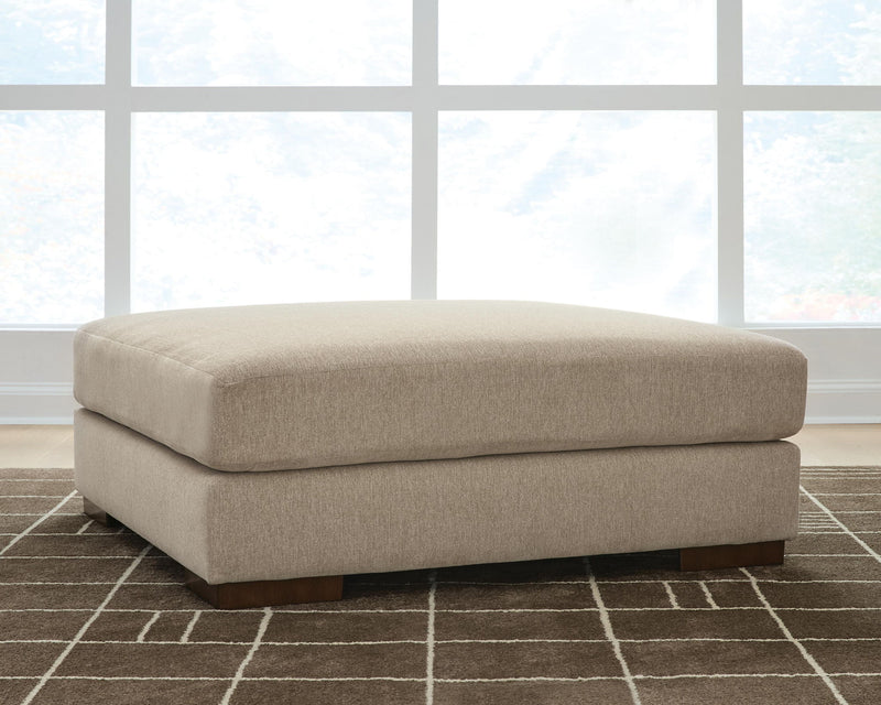 Linenhause oversized ottoman with soft dune beige fabric top and dark wooden legs