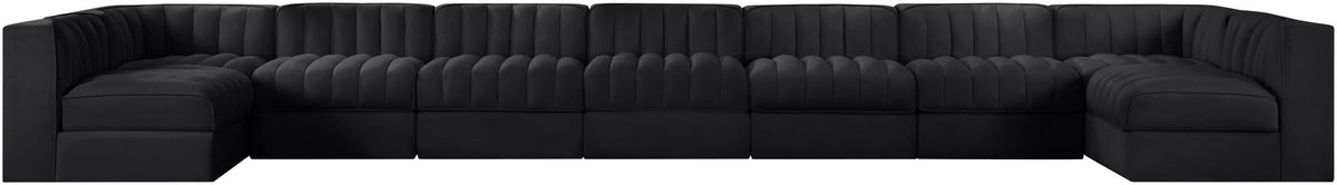 Black armless velvet modular sectional with tufted back and wide chaise seating