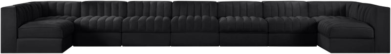 Black armless velvet modular sectional with tufted back and wide chaise seating