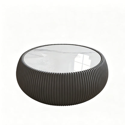 Drum-shaped coffee table with dark gray fluted base and clear glass top