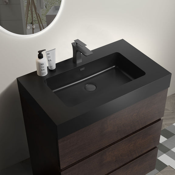 Freestanding bathroom vanity with black sink basin, tall faucet, dark wood cabinet drawers