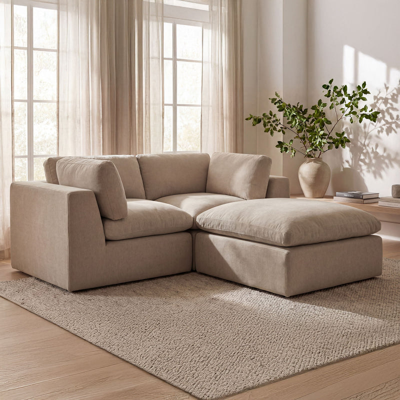 Beige modular sectional sofa with chaise ottoman and smooth fabric upholstery, corner layout
