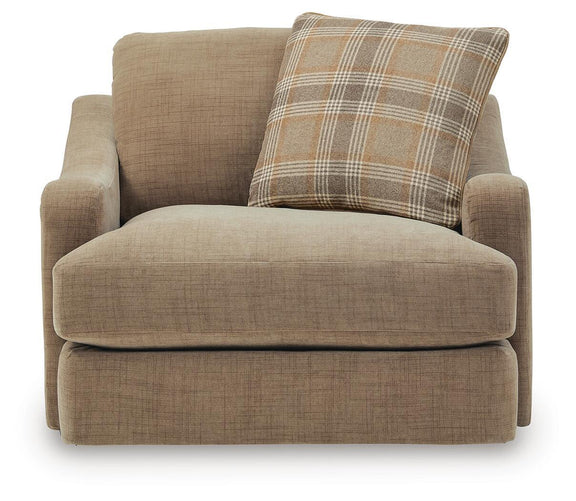 Tan chair and a half with large plaid back pillow and padded arms