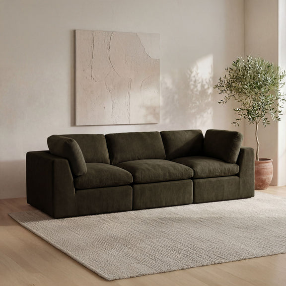 Dark green modular sofa with corner chaise, wide arms, deep boxy cushions