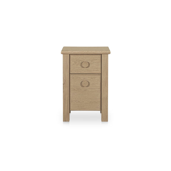 Natural wood small nightstand with two drawers and circular pulls.