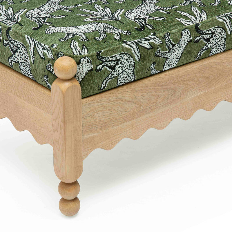 Green leopard jacquard bench with close-up wooden legs and scalloped skirt