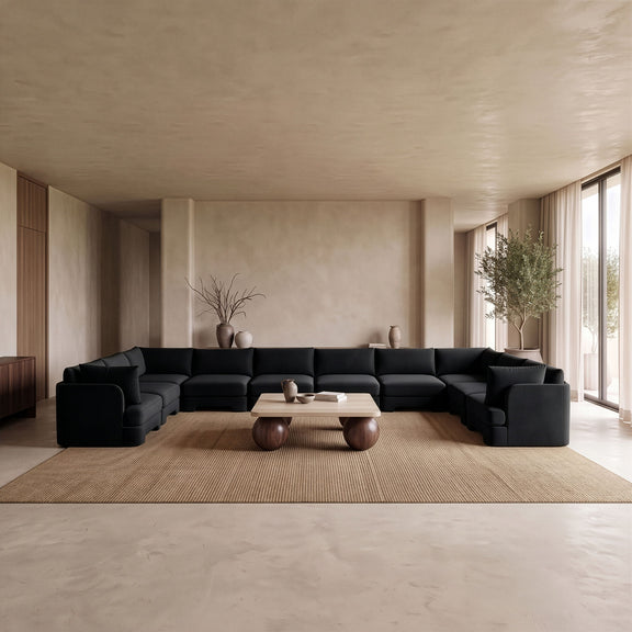Black velvet performance sectional sofa with multiple padded cushions and armrests.