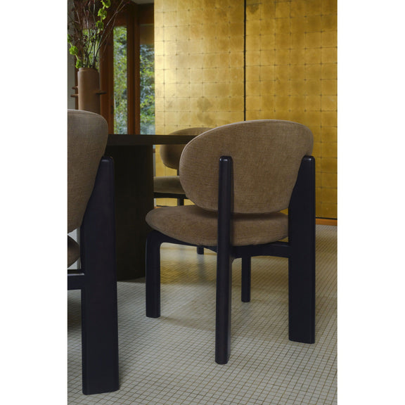 Tan upholstered dining chair with curved back and dark brown legs, three-quarter angle