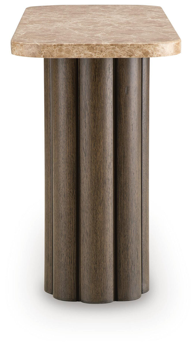 Rectangular table with speckled light stone top and dark fluted column base