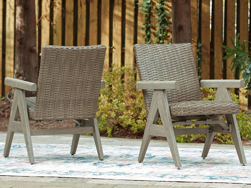 Two beige woven rocking arm chairs with light wood arms