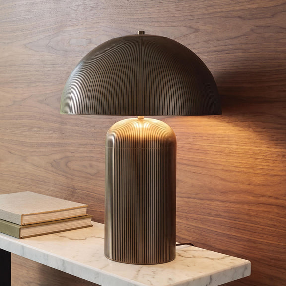 Dorriham metal table lamp with ribbed light bronze shade and glowing bulb