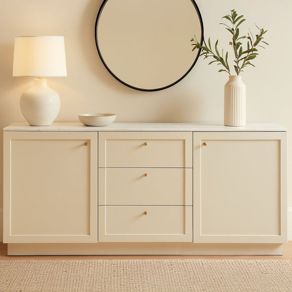 Cream sideboard with two cabinet doors and three central drawers, gold knobs