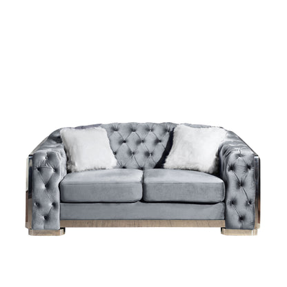 Dark gray two-seat loveseat sofa with button-tufted tufted back and plush pillows