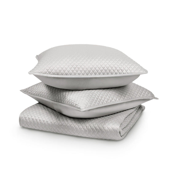 Stacked white diamond-quilt pillows/liners with stitched diamond pattern and clean edges