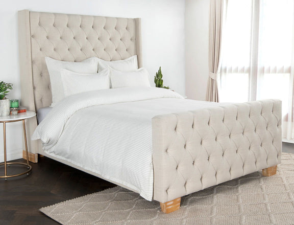 Ivory striped duvet with matching white shams on bed