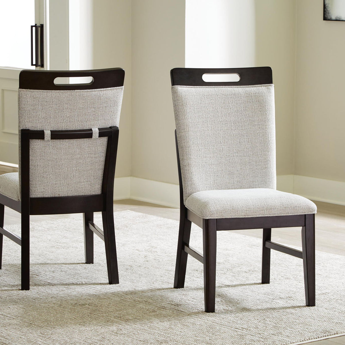 Set of 2 upholstered dining side chairs with light gray seats on rug