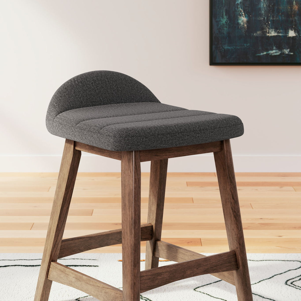 Upholstered barstool with charcoal gray fabric cushioned seat and curved back, wooden base