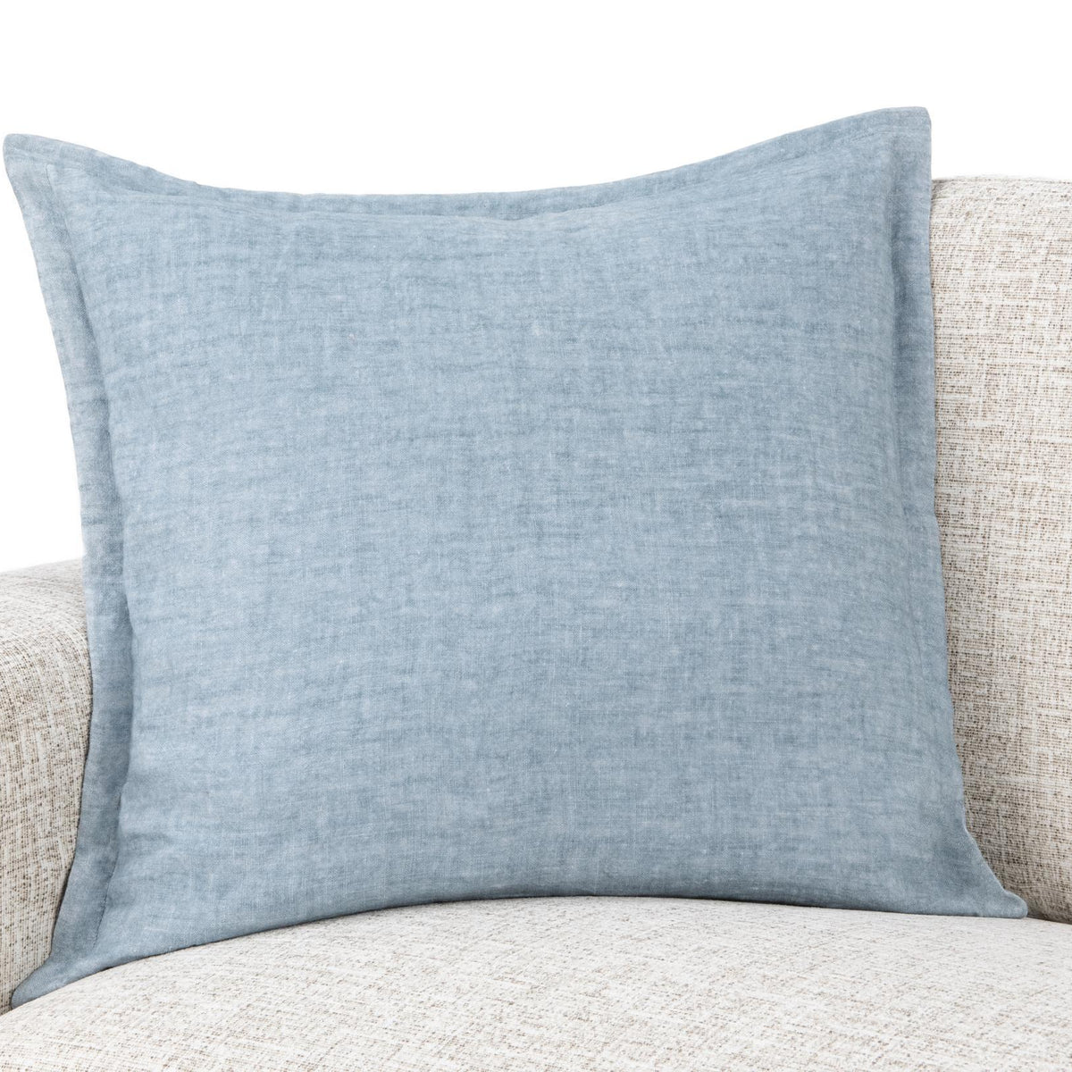 Blue square throw pillow on beige sofa cushion