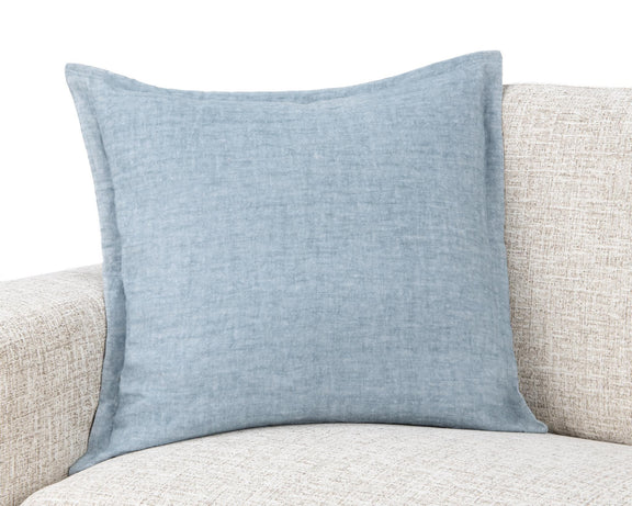 Blue square throw pillow on beige sofa cushion