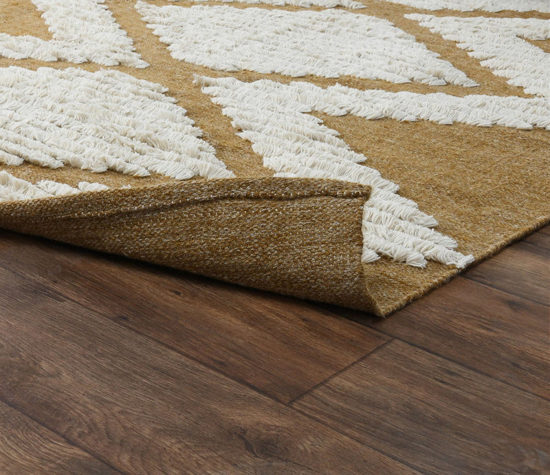 Indoor/outdoor rug corner showing folded edge and cream diamond stripes on tan background