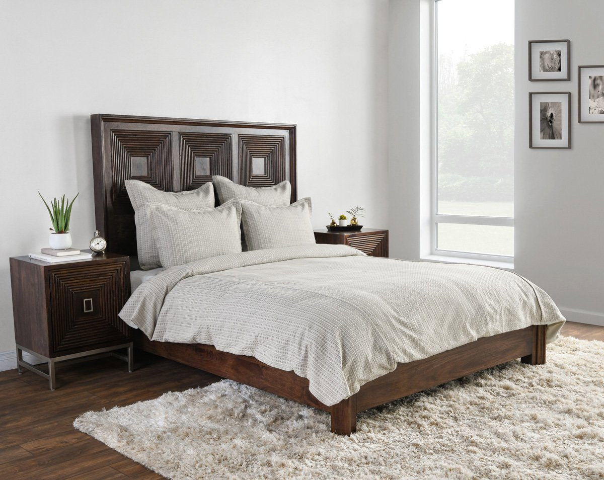 Light gray fabric pillow sham with vertical stripes on a bed