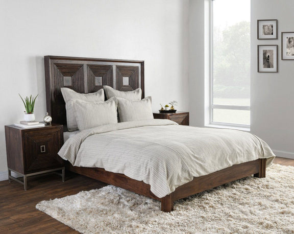 Light gray fabric pillow sham with vertical stripes on a bed