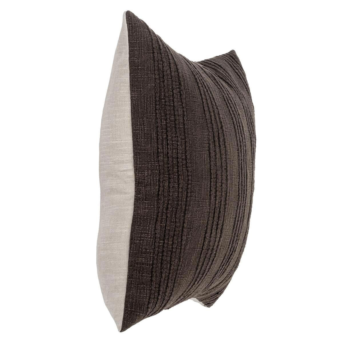 Two-tone dark brown and cream lumbar pillow shown from the side