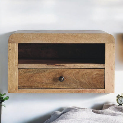 Floating bedside nightstand with open shelf and one drawer, light brown wood finish.