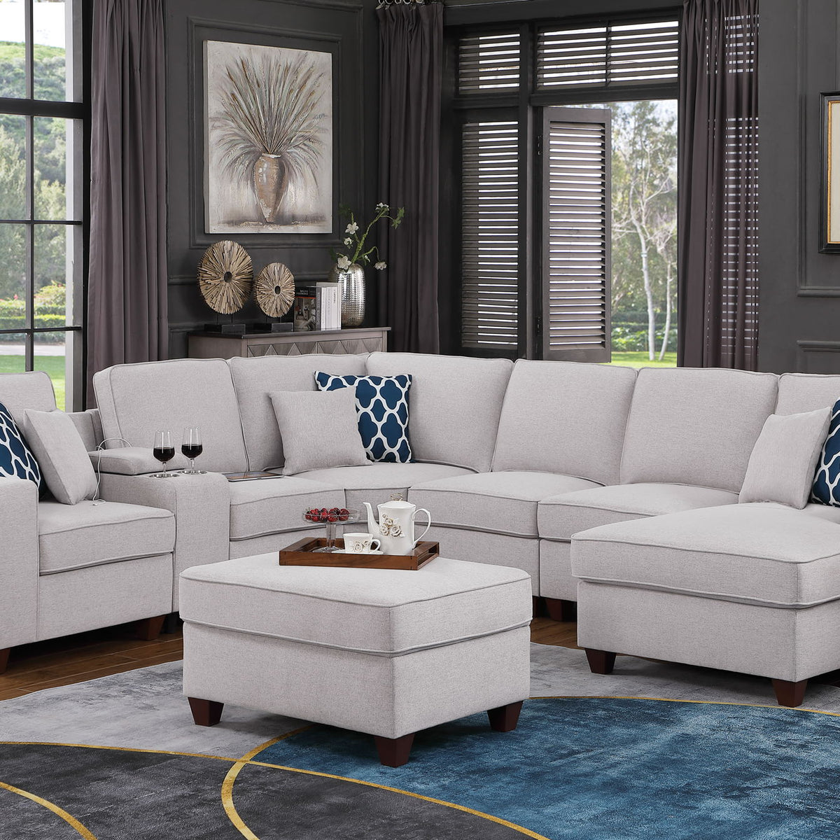 Light gray sectional sofa with ottoman and blue patterned throw pillows