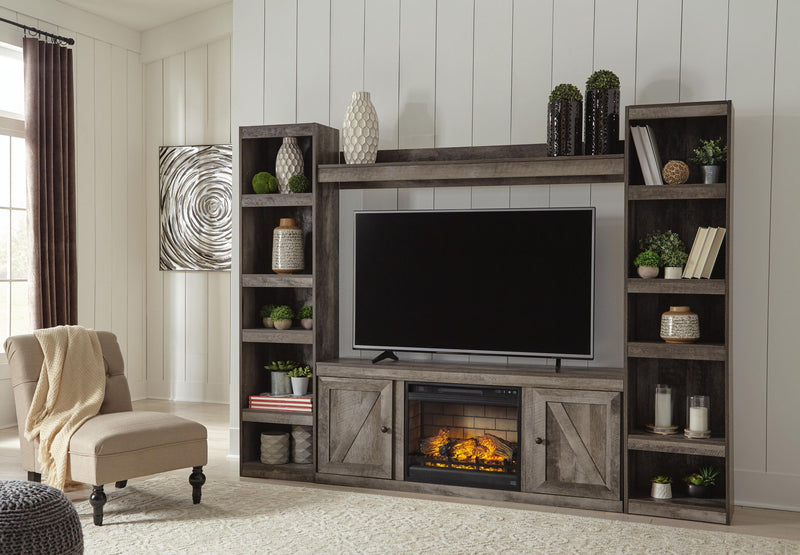 Gray entertainment center with wide TV opening, shelving, and built-in faux fireplace