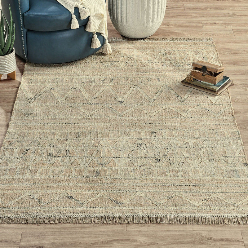 Distressed light beige rug with flatwoven texture and fringed border