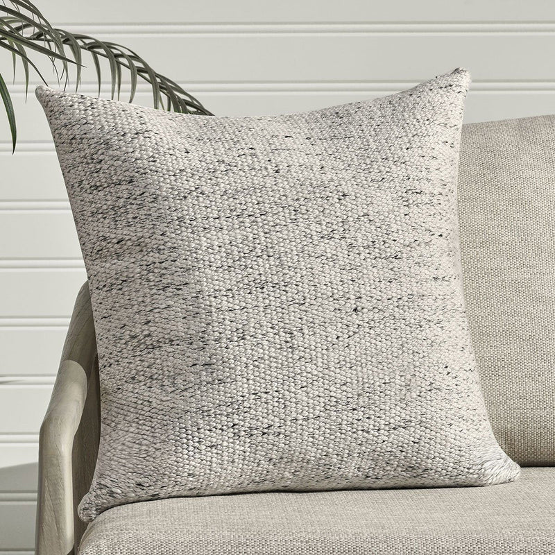 Textured woven lumbar pillow, off-white with light speckling and piped edges