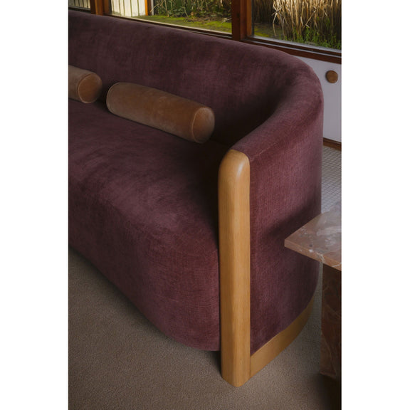 Berry purple velvet sofa arm and back with light wood corner legs