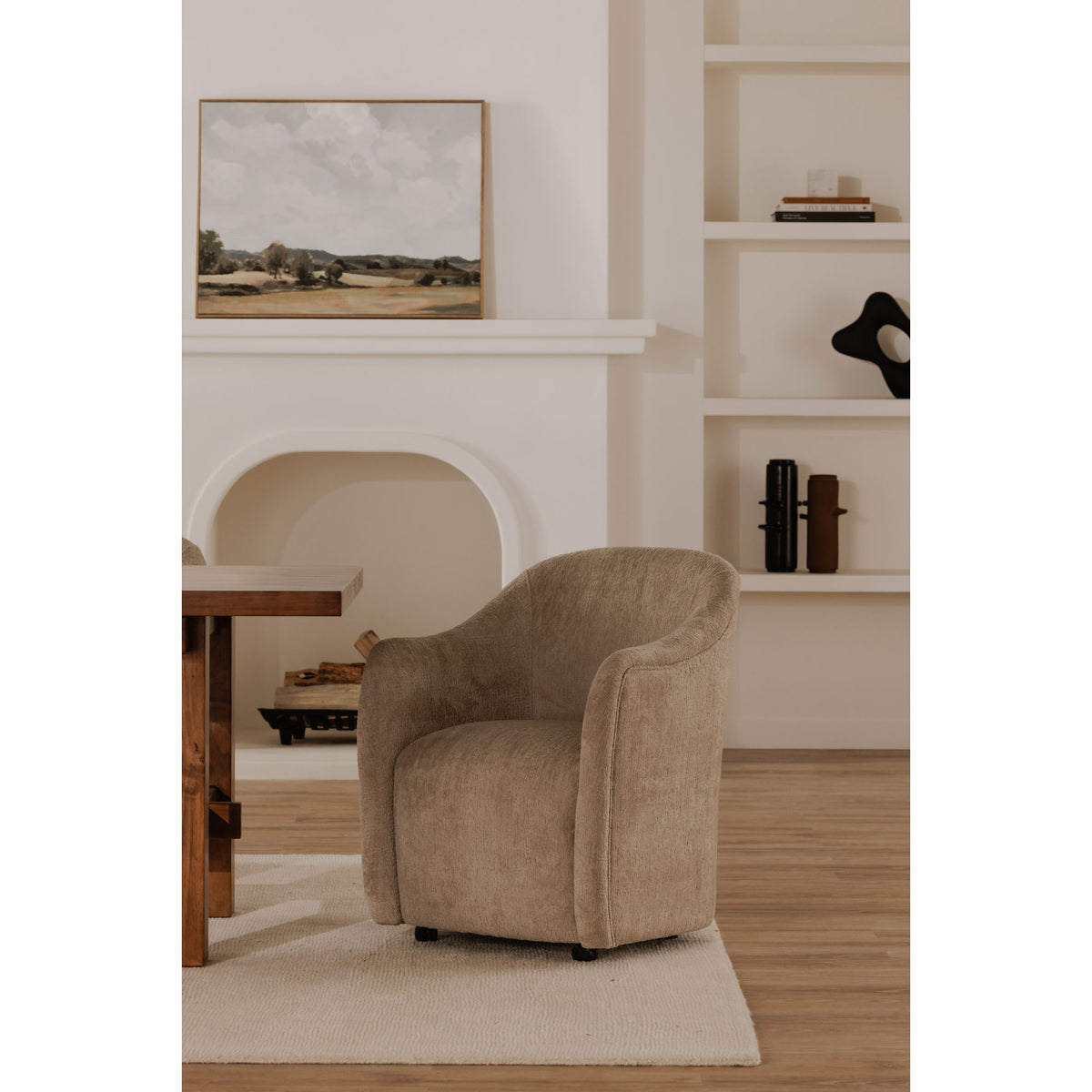 Beige fabric rolling dining chair with rounded backrest, arms, and caster wheels