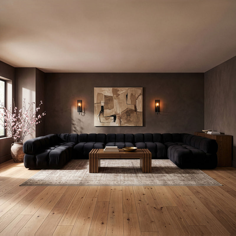 Black U-shaped modular sectional sofa with tufted cushions and rounded corners
