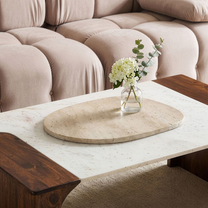 Beige genuine marble decorative tray on tabletop, oval with subtle speckles