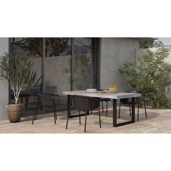 Outdoor dining table with cement-look round-corner top and black steel base.