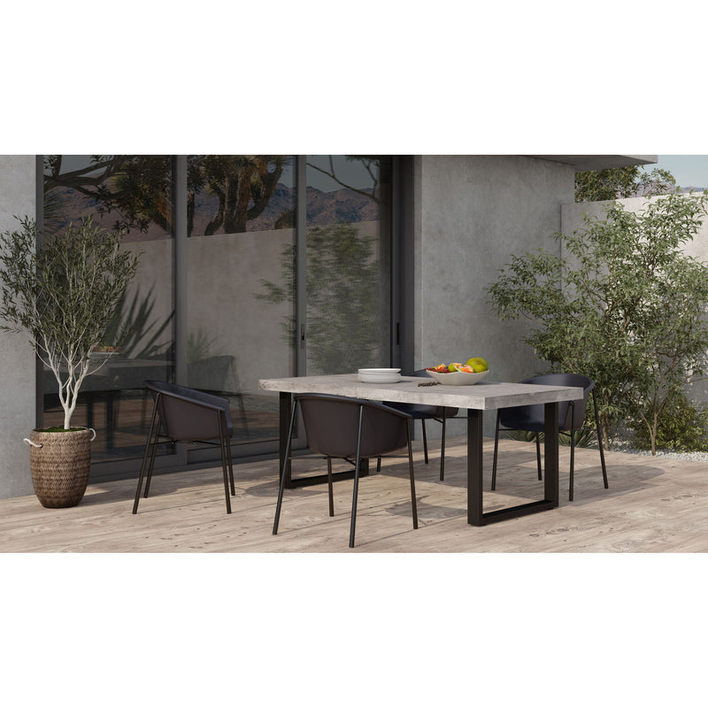 Outdoor dining table with cement-look round-corner top and black steel base.