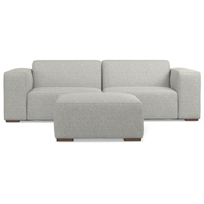 Gray fabric 2-seater sectional sofa with ottoman, two back cushions and rolled arms.