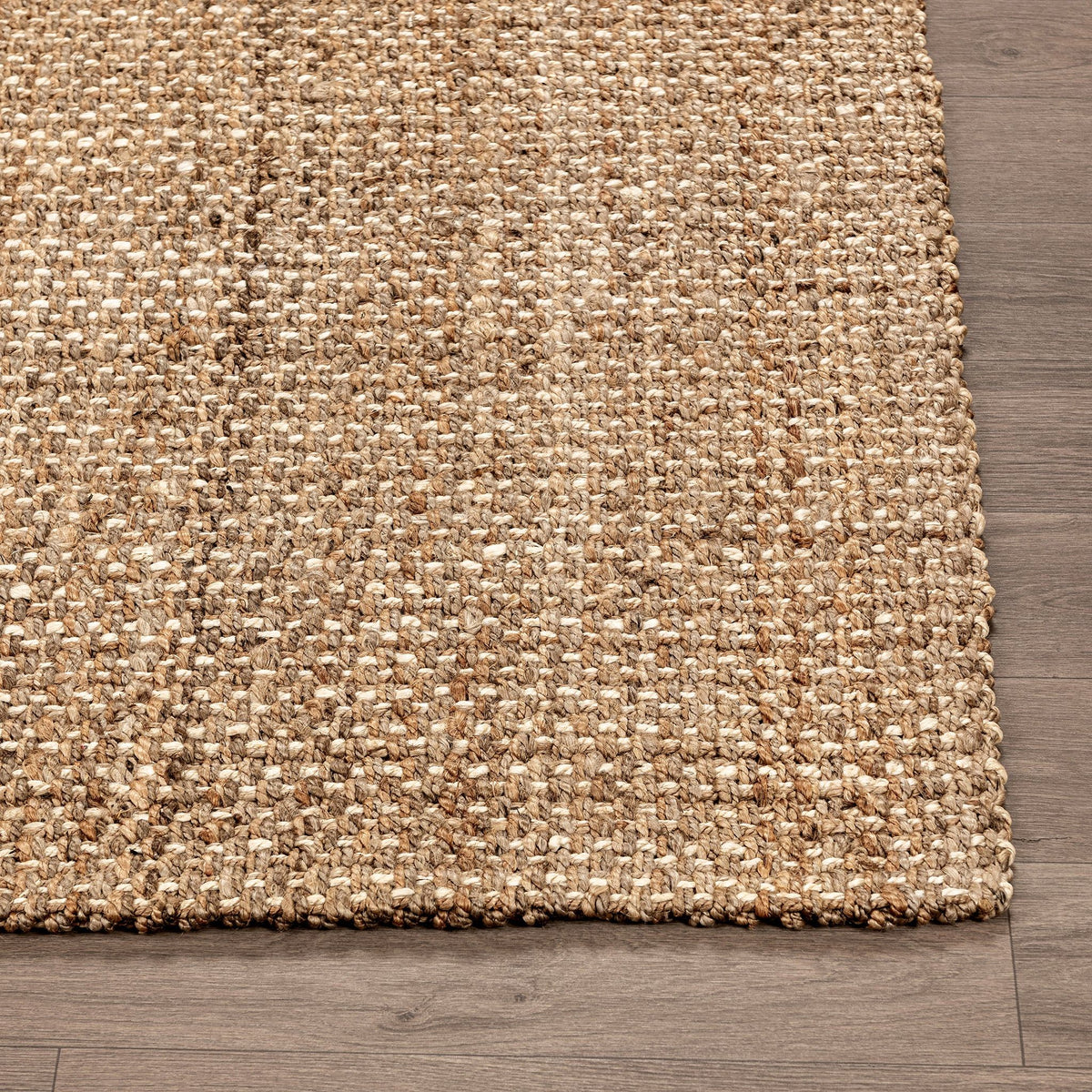 Jute rug corner detail with open weave texture and short braided fringe