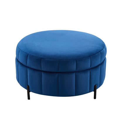 Blue upholstered round ottoman with tufted channels, padded top, and black legs
